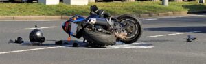 Motorcycle accident with bike on its side on roadway